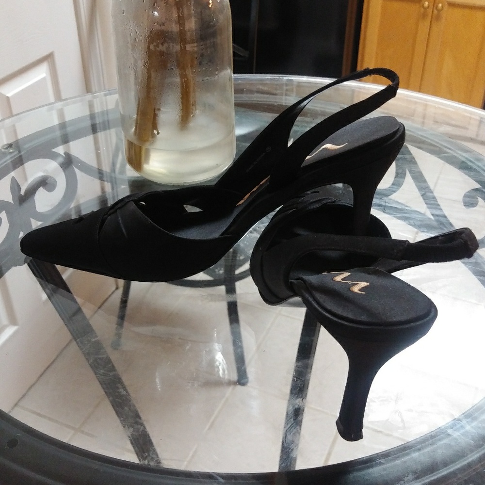 A pair of black satin shoes